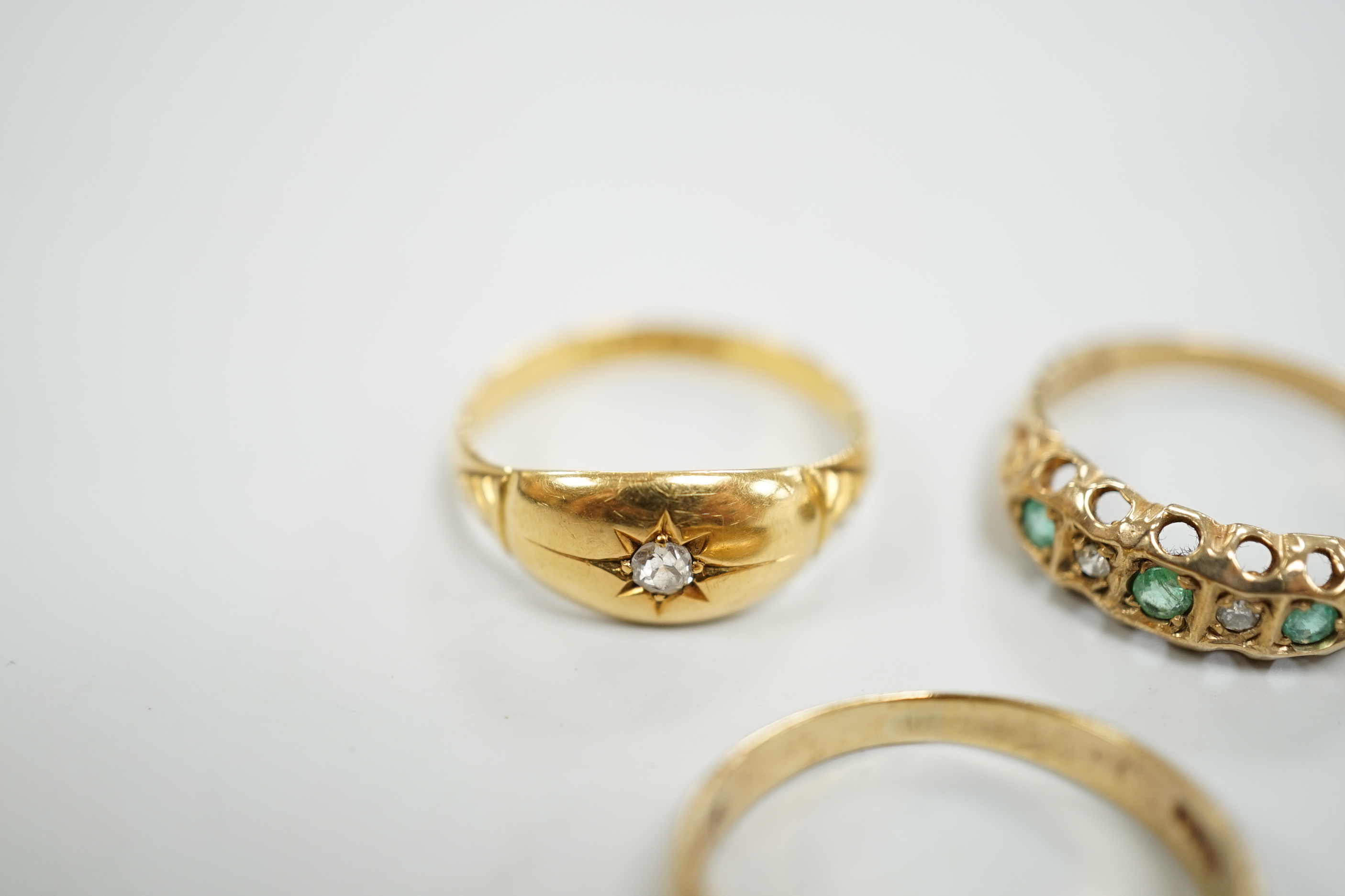 An Edwardian 18ct gold and diamond chip set ring, size M, gross weight 2.6 grams and two later 9ct gold and gem set rings, gross weight 5.5 grams.